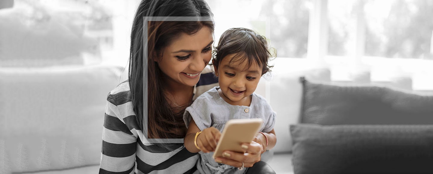 Indian mother and child playing game on the smartphone